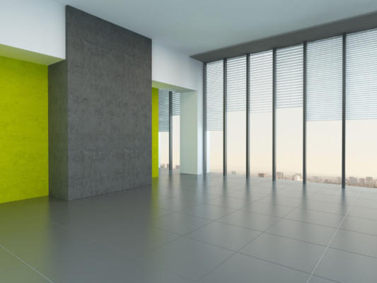 Interior architectural background of a large empty room with yellow wall accents and floor-to-ceiling panoramic windows reflecting on a grey floor